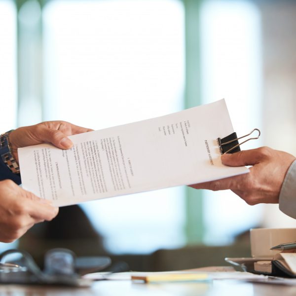 closeup-hands-passing-contract-unrecognizable-businessman